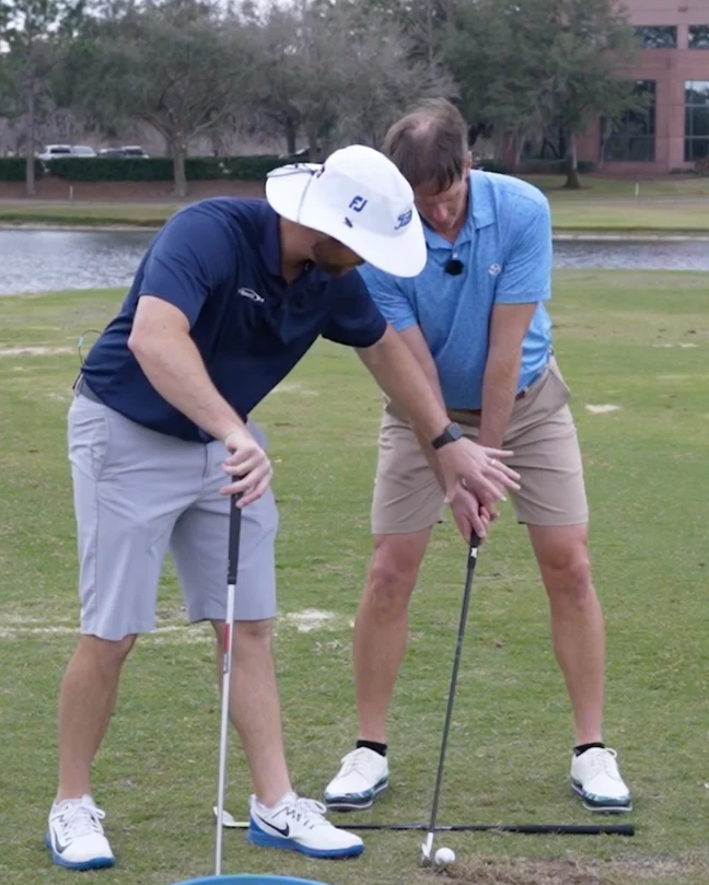 Clay Ballard coaching a student on the range